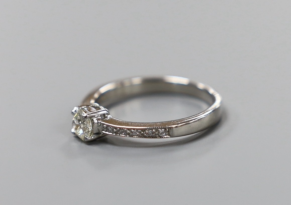 A modern platinum and single stone diamond ring, with diamond set shoulders, size M, gross weight 3.7 grams